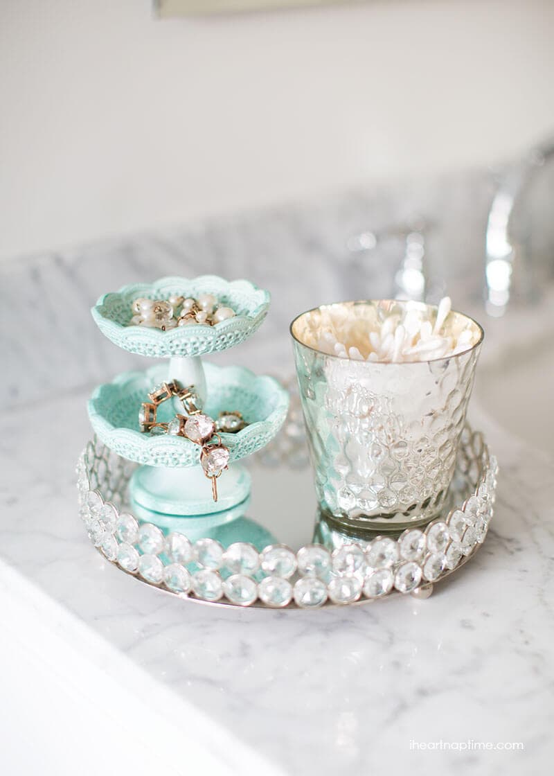 Bathroom makeover via I Heart Naptime: Grey and white bathroom remodel with Carrara marble herringbone tile tile, white vintage tub and blue accents. 