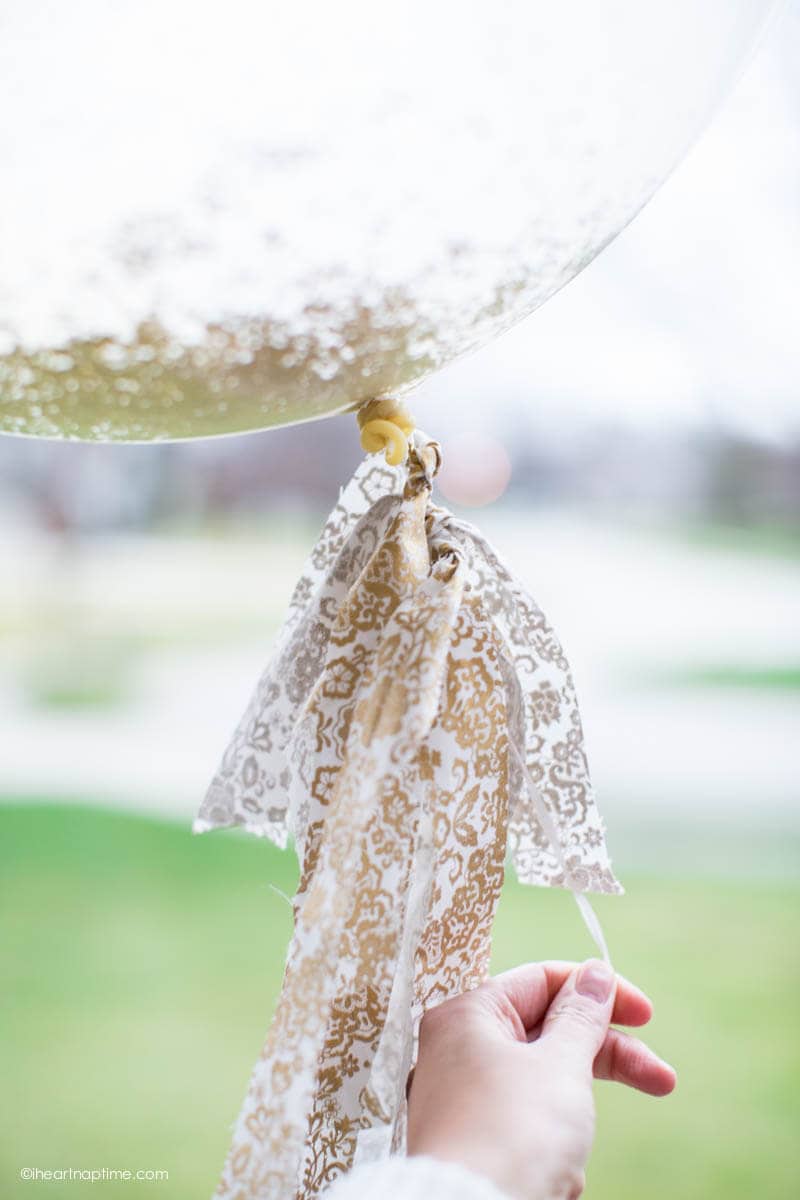 Glitter Balloons - last minute NYE idea! A simple way to add a big impact at your party! Bring some sparkle to any party by adding glitter and fabric scraps to your clear balloons!