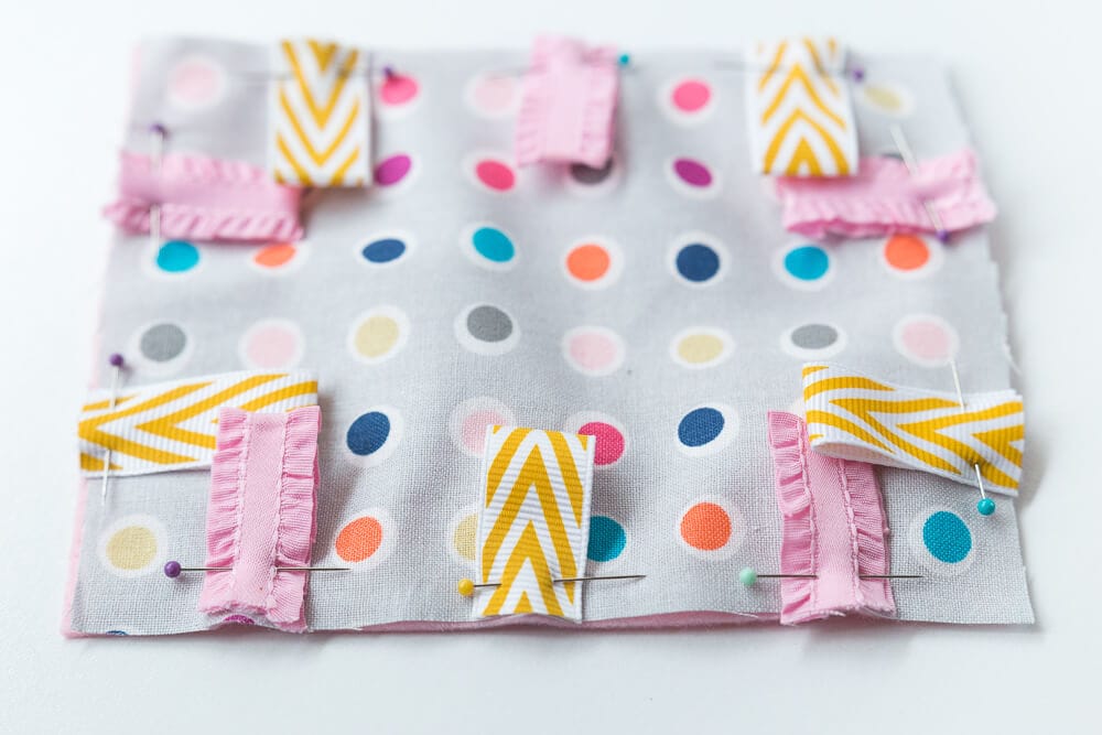 Taggie Baby Toy - a simple sewing project perfect for any new baby. Colorful ribbons and a bright pattern makes this a great sensory toy for your little one. 