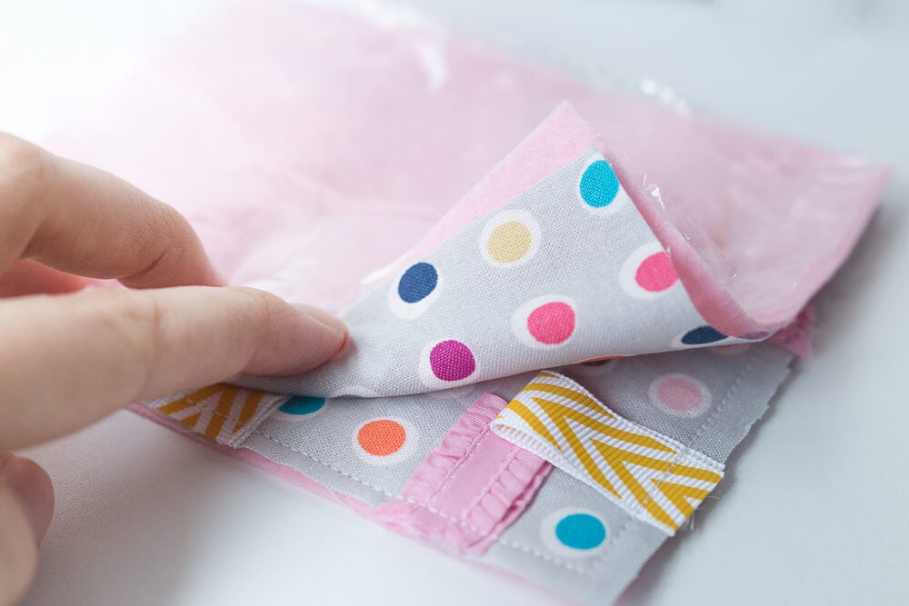 Taggie Baby Toy - a simple sewing project perfect for any new baby. Colorful ribbons and a bright pattern makes this a great sensory toy for your little one. 