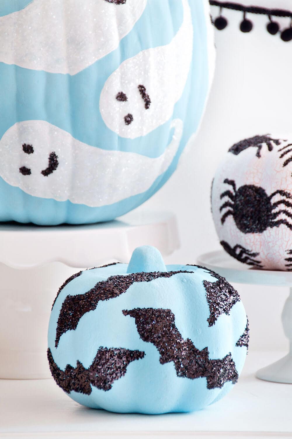 blue and white glitter decorated pumpkins 