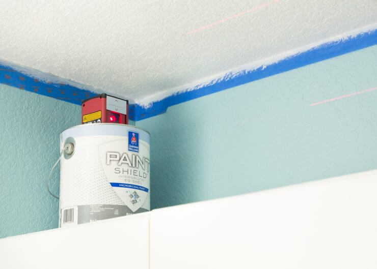 How to Paint a Striped Ceiling ... an unexpected striped ceiling in the laundry room is the perfect pop of surprise in a much-used room that helps making laundry more fun!