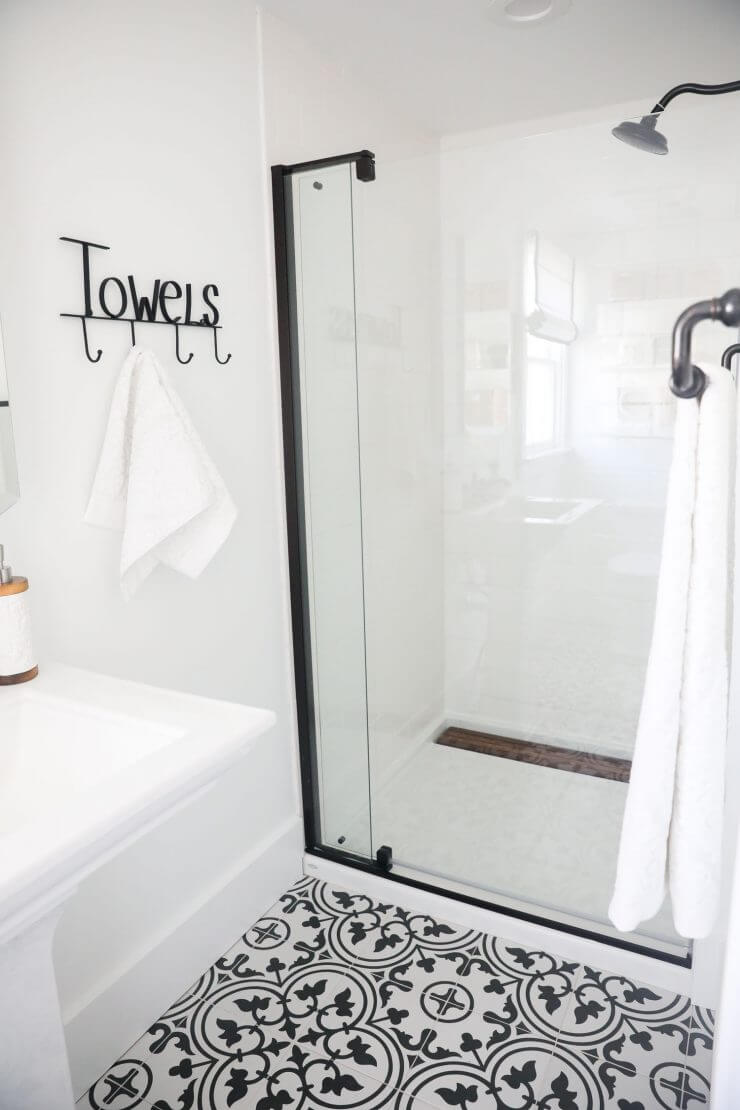 Black and white bathroom makeover on a 1888 fixer upper: white subway tile, oil rubbed bronze finishes + cement tile 