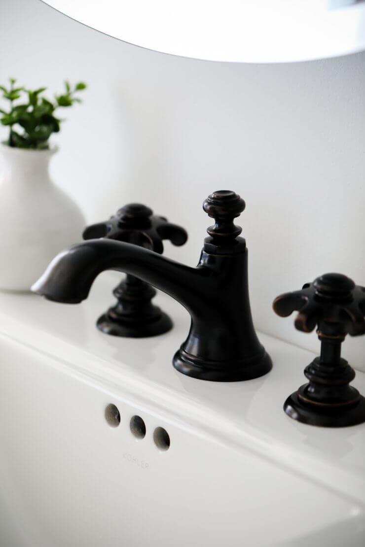 Black and white bathroom makeover on a 1888 fixer upper: white subway tile, oil rubbed bronze finishes + cement tile 