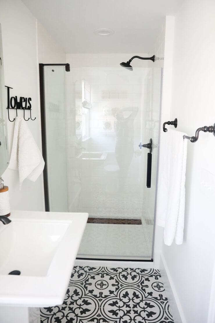 Black and white bathroom makeover on a 1888 fixer upper: white subway tile, oil rubbed bronze finishes + cement tile 