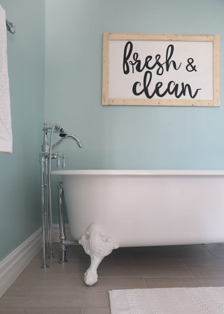 Fixer Upper Bathroom Before and Afters... fixer upper style bathroom makeover with clawfoot tub, watery paint color and sliding barn door.