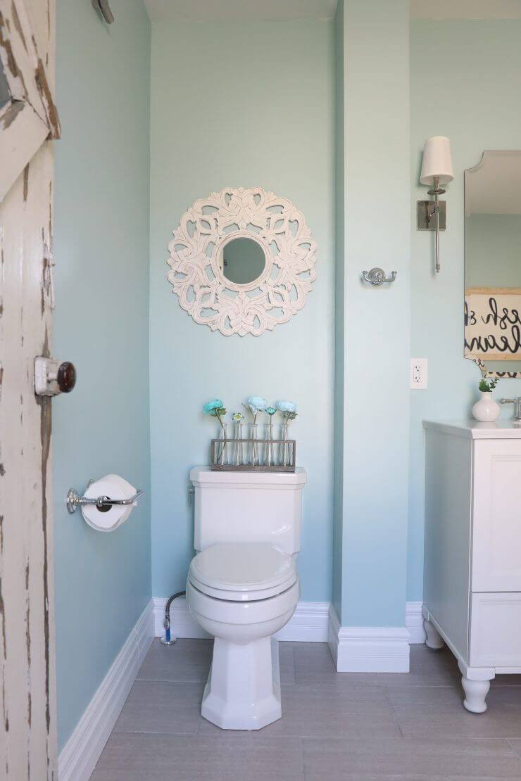 Fixer Upper Bathroom Before and Afters... fixer upper style bathroom makeover with clawfoot tub, watery paint color and sliding barn door.