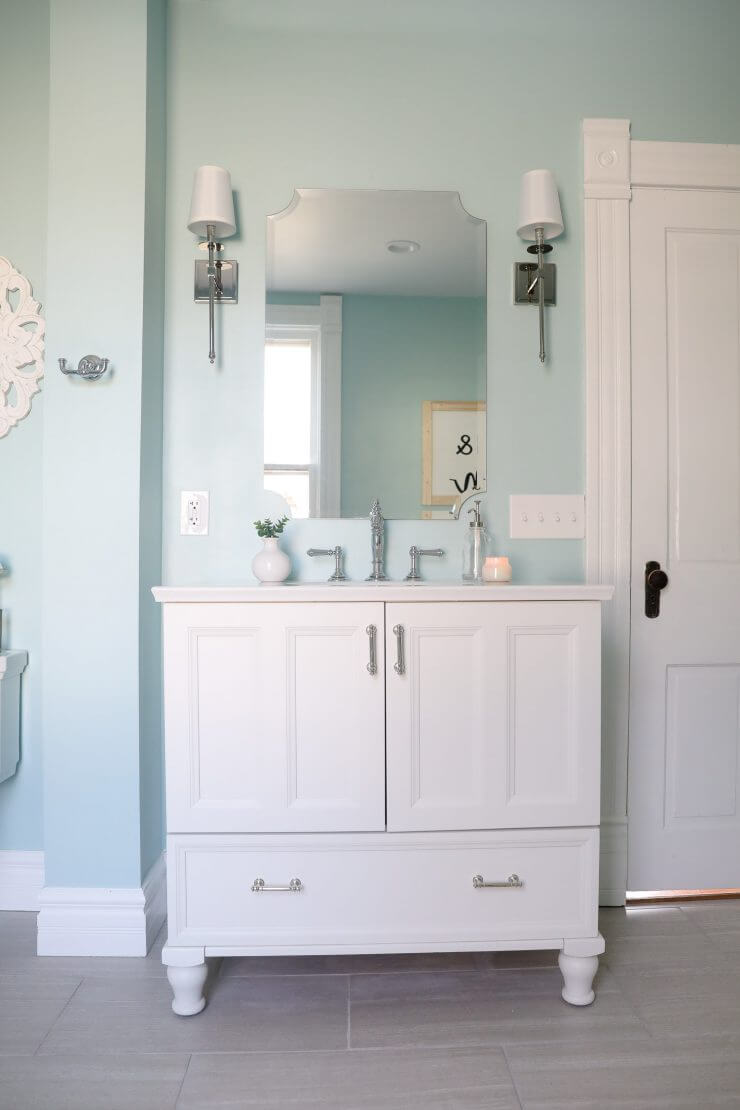 Fixer Upper Bathroom Before and Afters... fixer upper style bathroom makeover with clawfoot tub, watery paint color and sliding barn door.