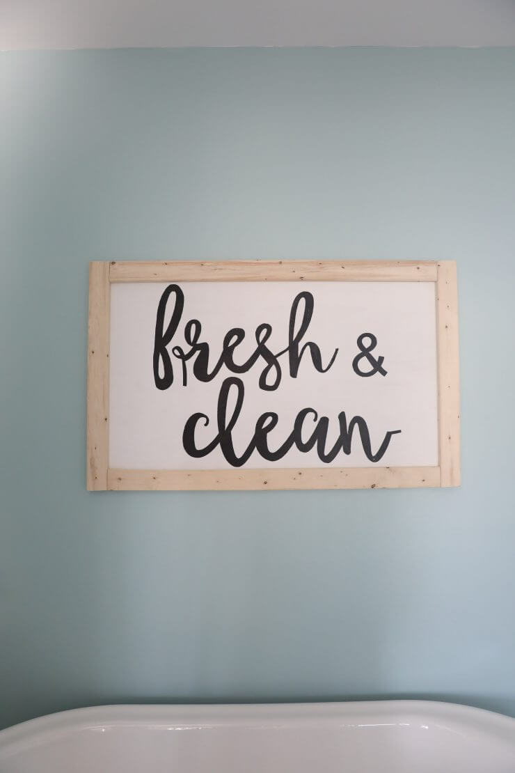 Fixer Upper Bathroom Before and Afters... fixer upper style bathroom makeover with clawfoot tub, watery paint color and sliding barn door.