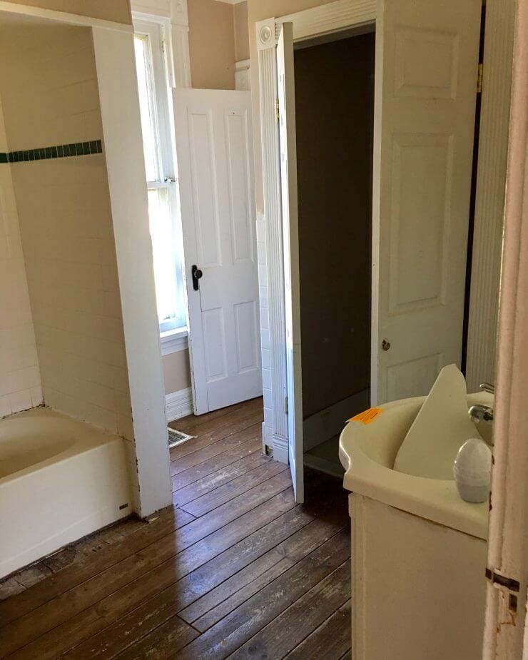 Fixer Upper Bathroom Before and Afters... fixer upper style bathroom makeover with clawfoot tub, watery paint color and sliding barn door.