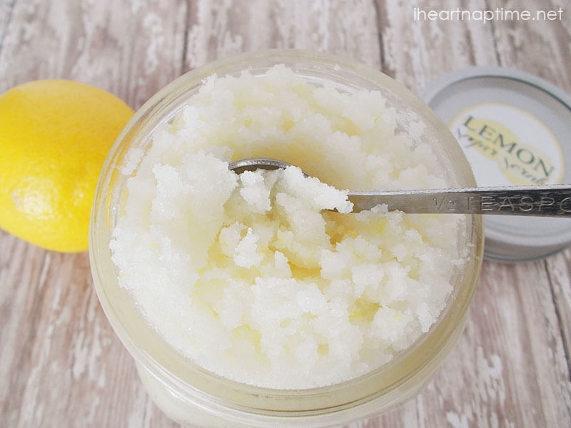 scooping a teaspoon out of a jar of lemon sugar scrub 