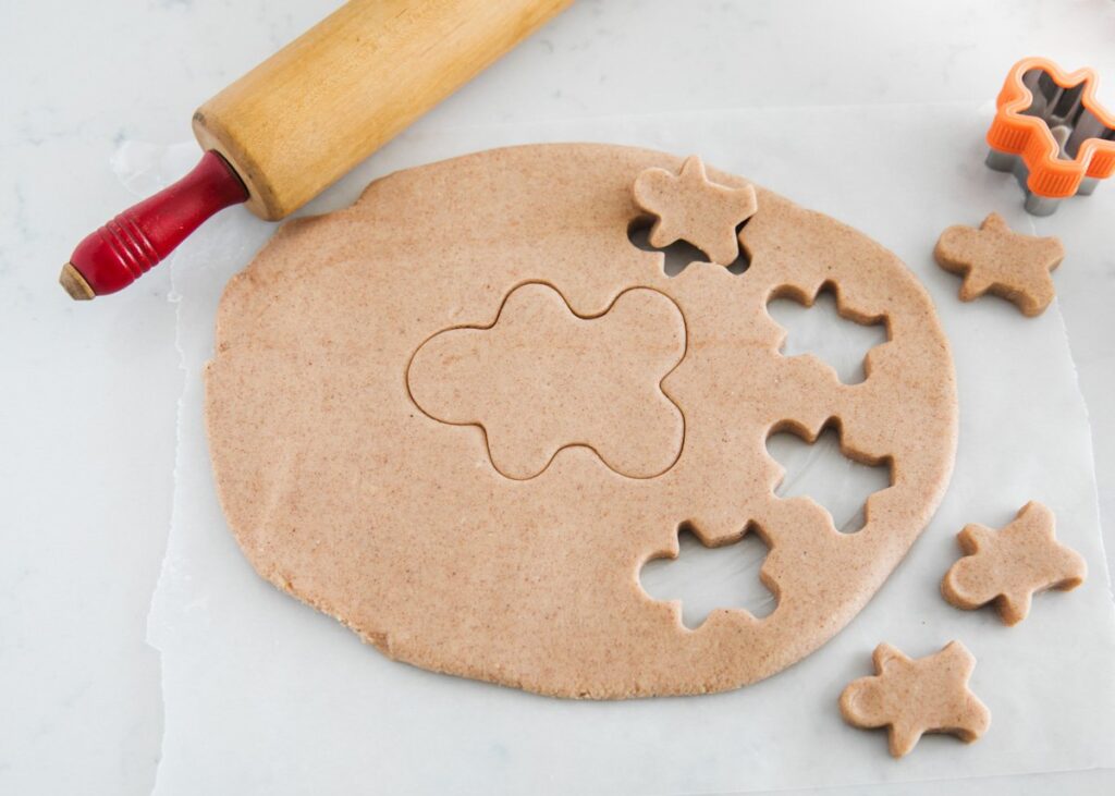Rolling out gingerbread playdough. 
