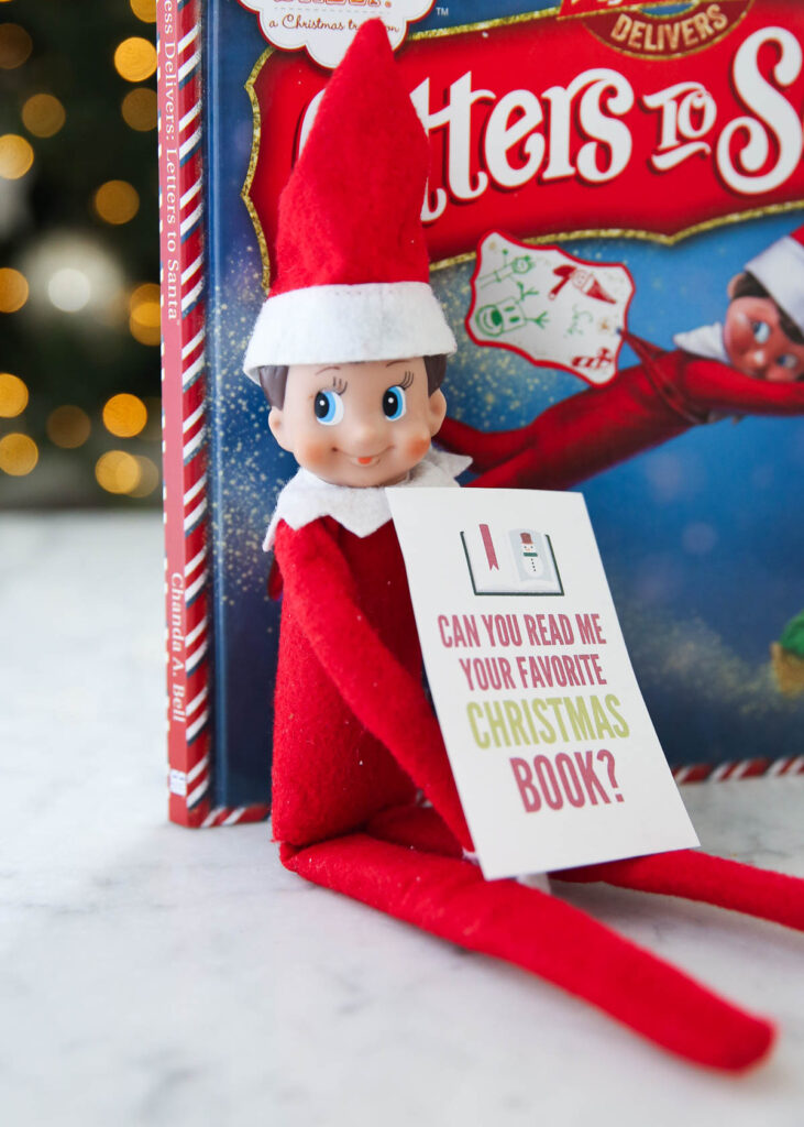 elf on the shelf next to the book