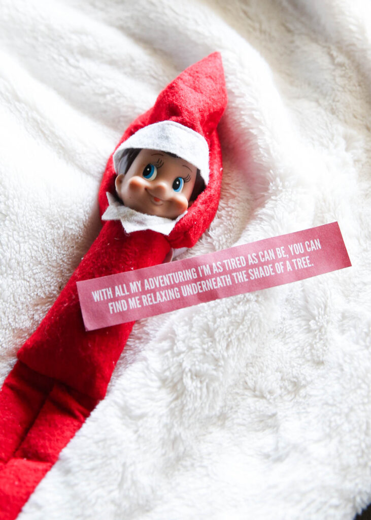 Elf laying on fleece blanket with a note.