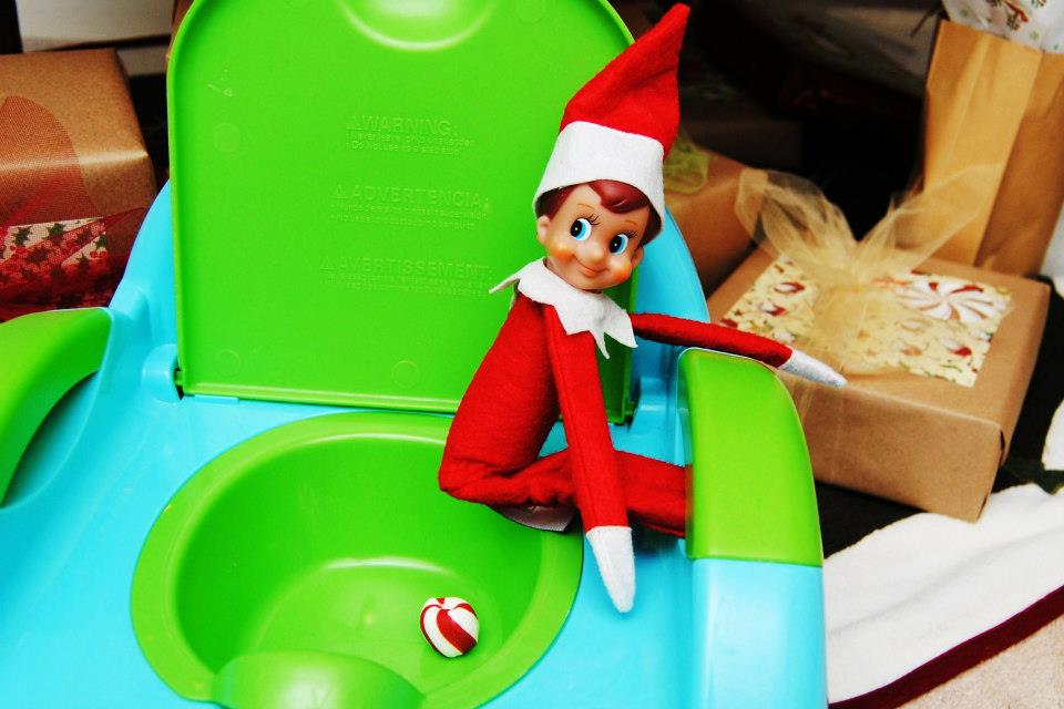 Elf sitting on a small toilet. 