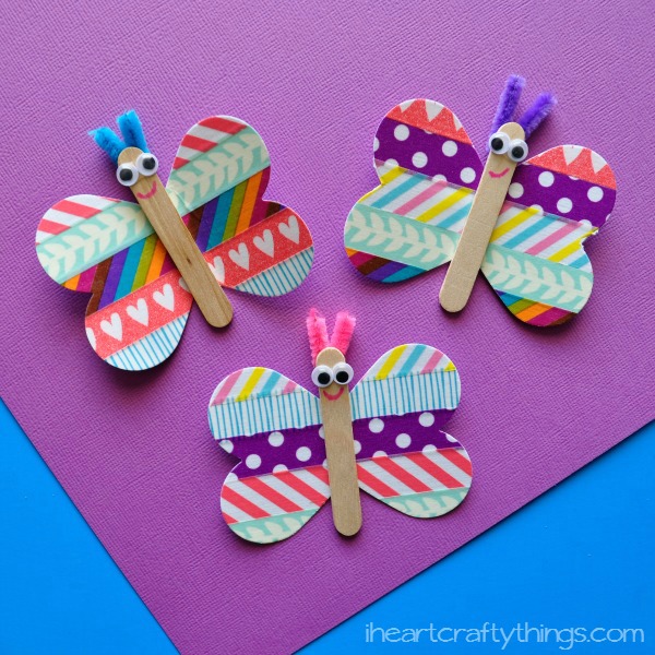 Popsicle Stick butterflies with paper wings decorated in washi tape